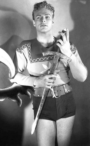 Buster Crabbe as Flash Gordon wearing a shirt with a star symbol in the 1936 serial "Flash Gordon."