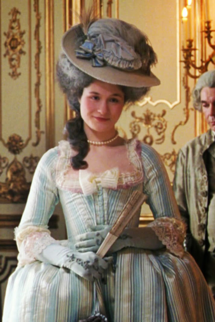 Mary Nighy as Princesse de Lamballe wearing a blue and white striped gown in the 2006 film "Marie Antoinette."