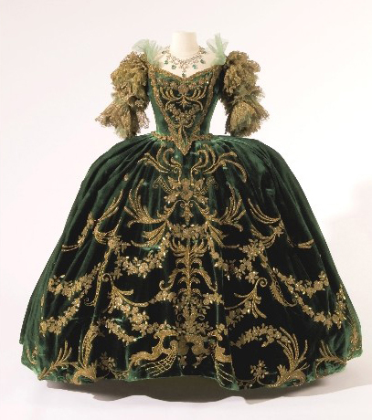 A green velvet gown decorated with gold embroidery and appliqués designed by Adrian for the 1938 film "Marie Antoinette."