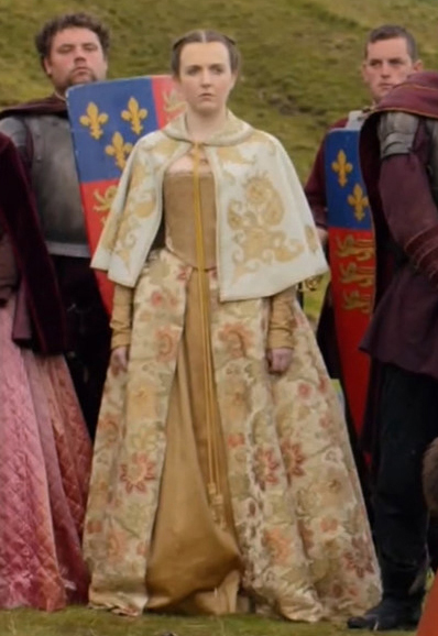 An extra as a Lady in Waiting wearing a gold gown in the 2013 series "Reign."
