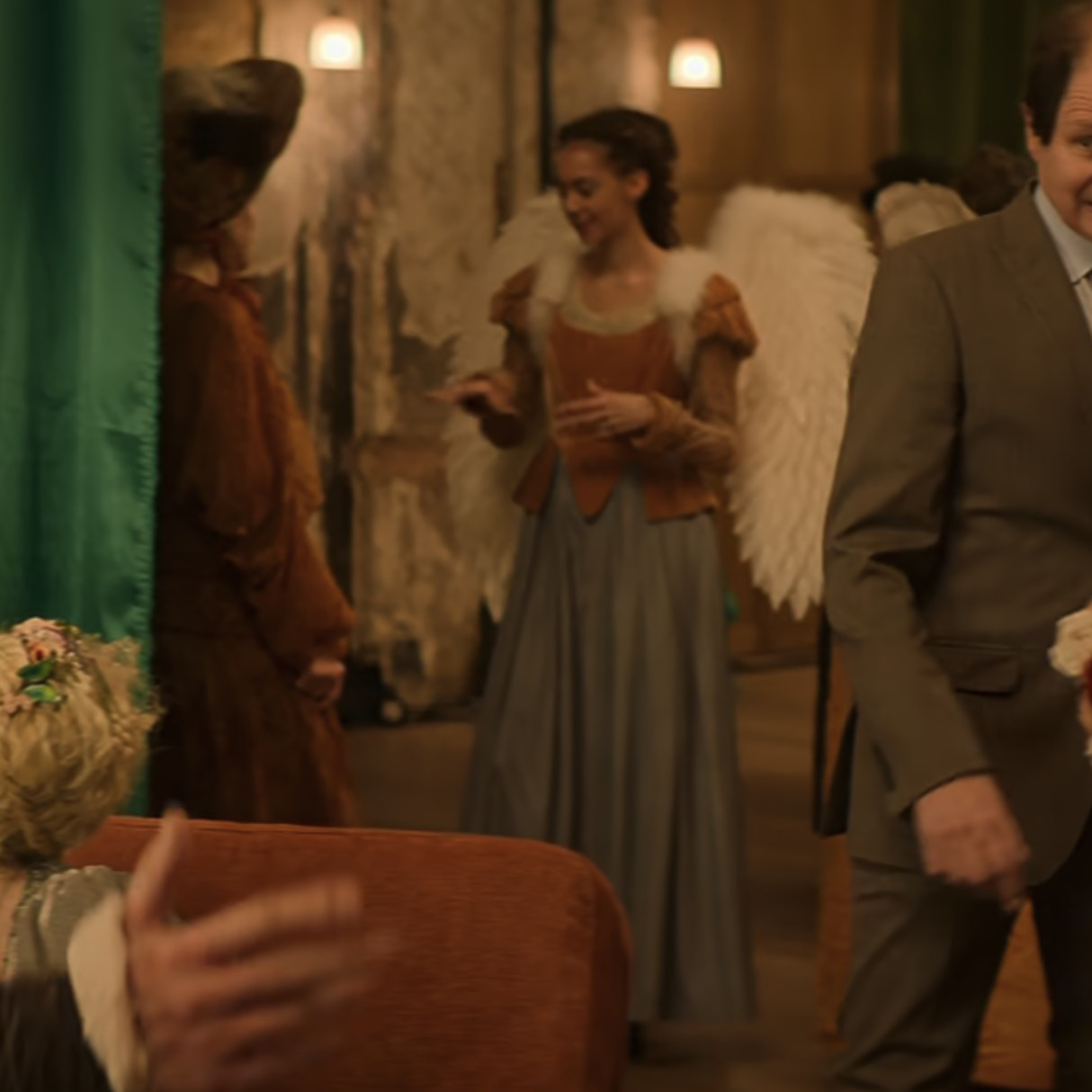 An extra wearing a brown and blue gown in the 2023 film "Love at First Sight."