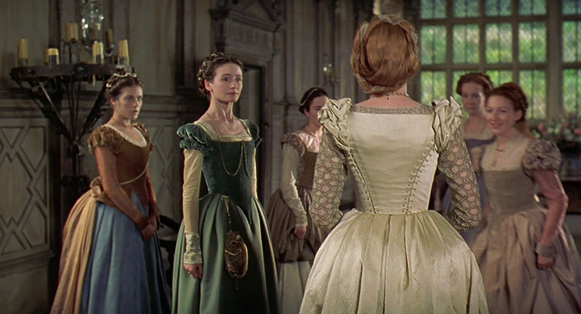 An extra as a lady in waiting wearing a brown and blue gown in the 1998 film "Elizabeth."