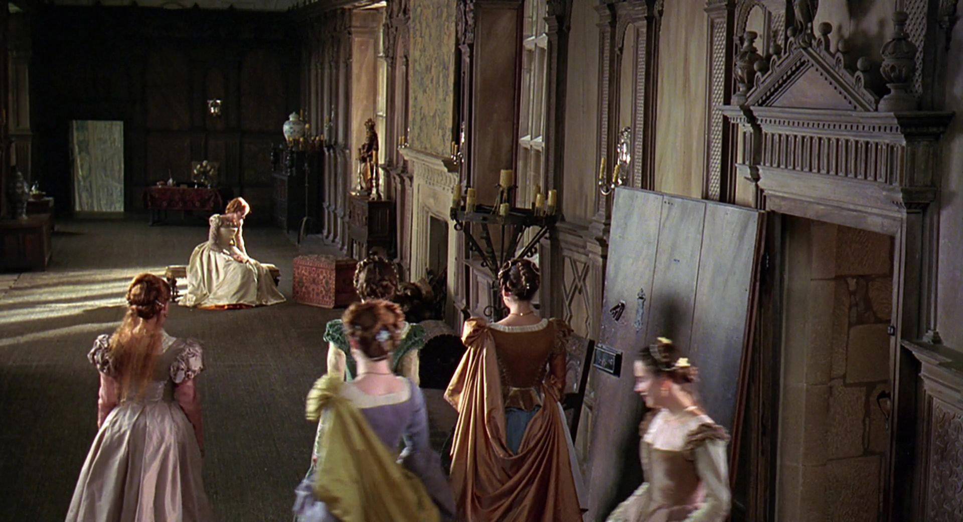 An extra as a lady in waiting wearing a brown and blue gown in the 1998 film "Elizabeth."