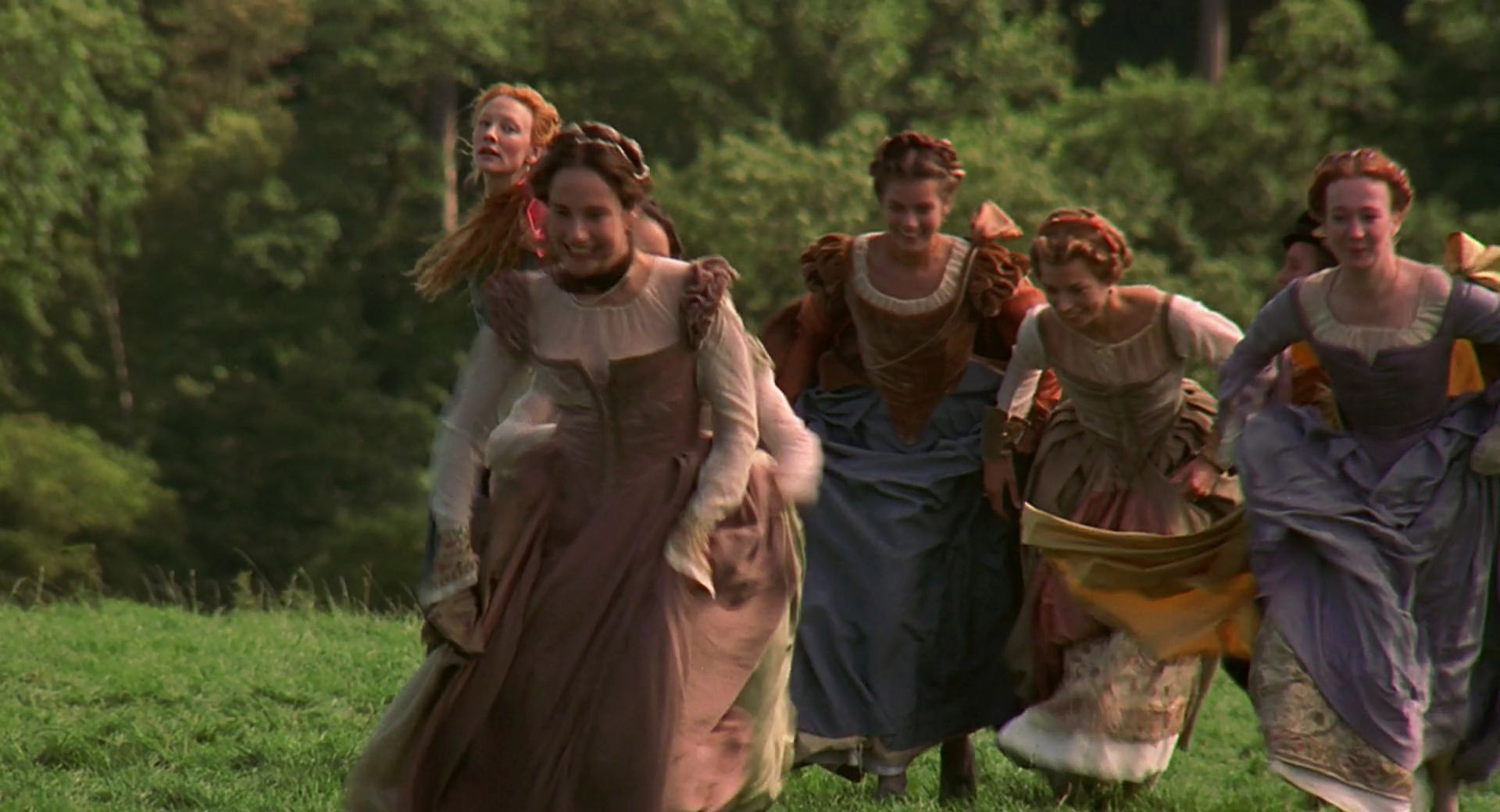 An extra as a lady in waiting wearing a brown and blue gown in the 1998 film "Elizabeth."