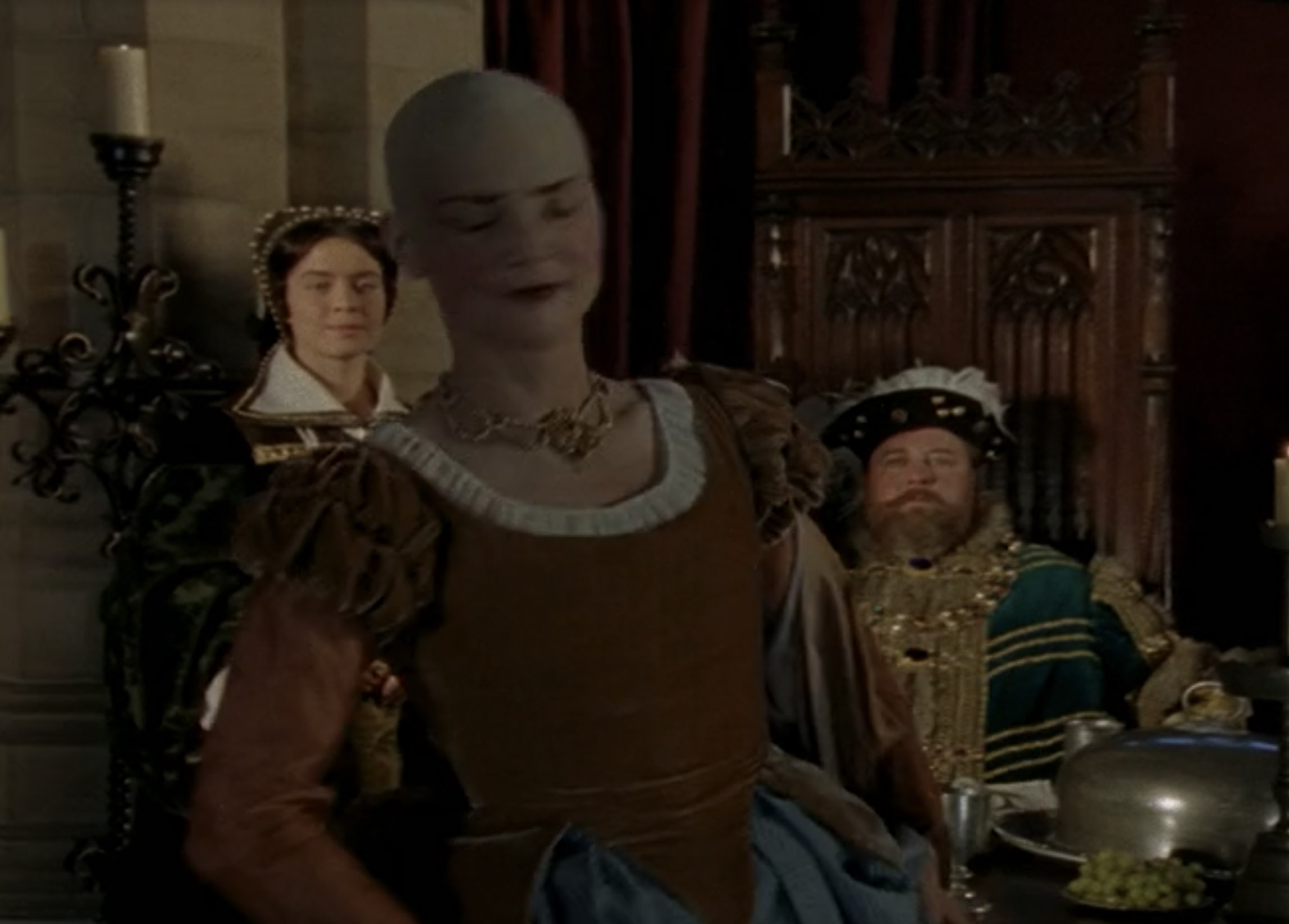 Susan Sheridan as Jane the Bald / Jane Foole wearing a brown and blue gown in the 2000 film "The Royal Diaries: Elizabeth I - Red Rose of the House of Tudor."