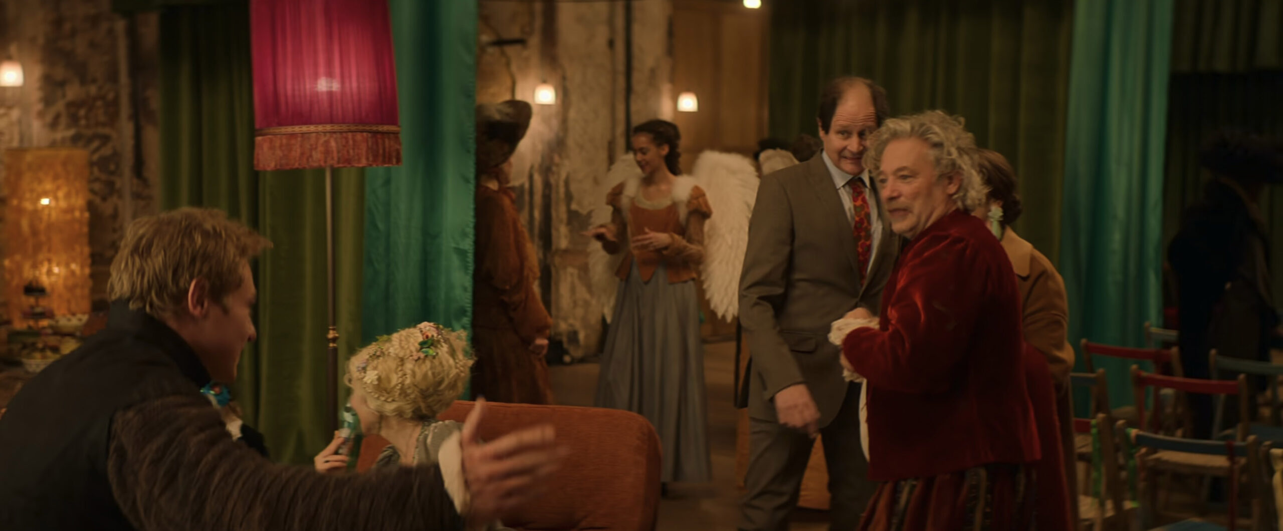 An extra wearing a brown and blue gown in the 2023 film "Love at First Sight."