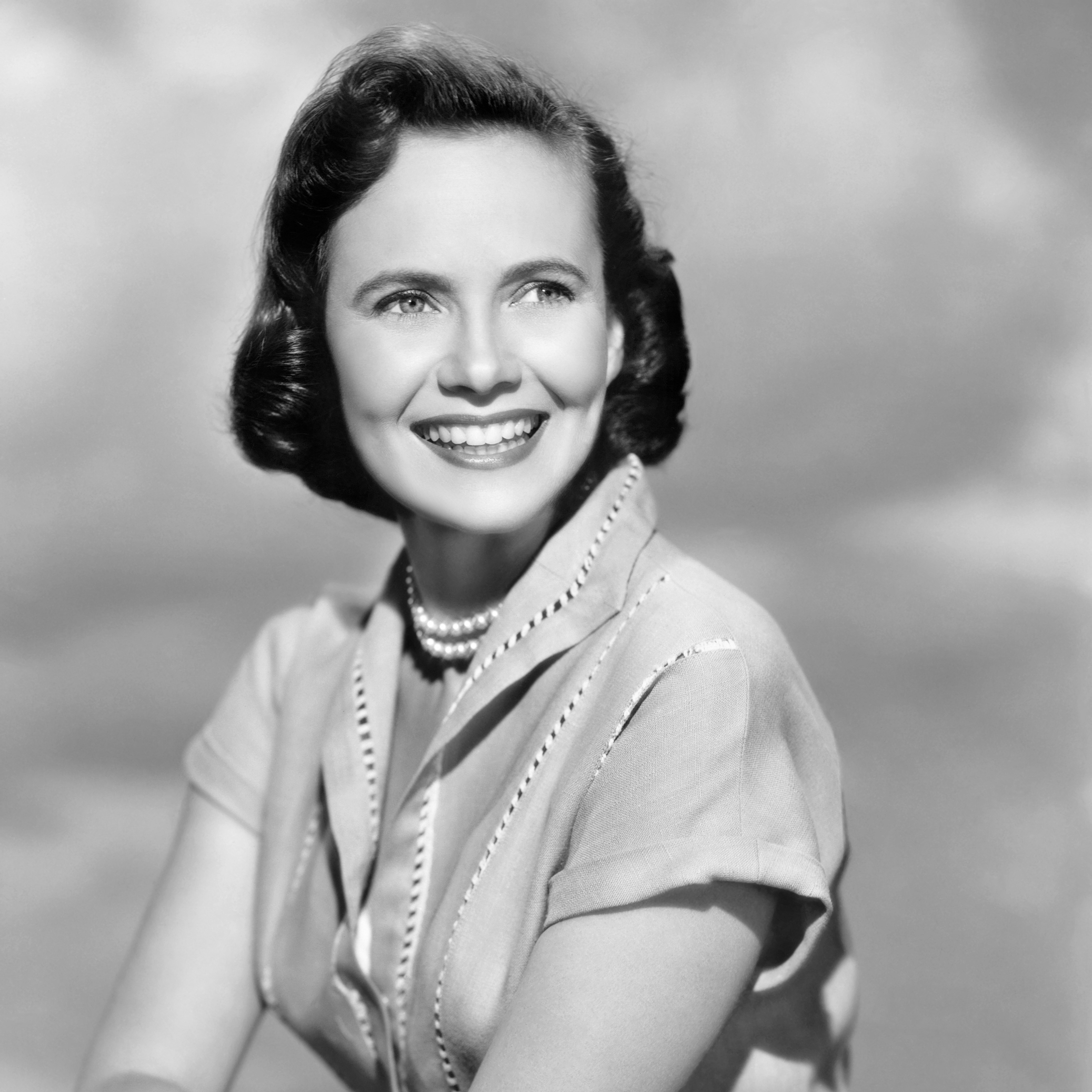 Teresa Wright as Edna Miller wearing a dress decorated with open vertical stitching in the 1952 film "Something to Live For."