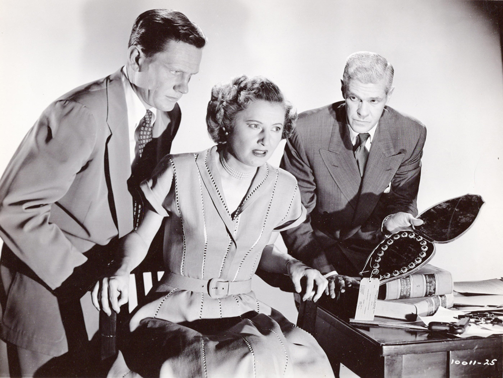 Barbara Stanwyck as Thelma Jordan wearing a dress decorated with open vertical stitching in the 1949 film "The File on Thelma Jordan."