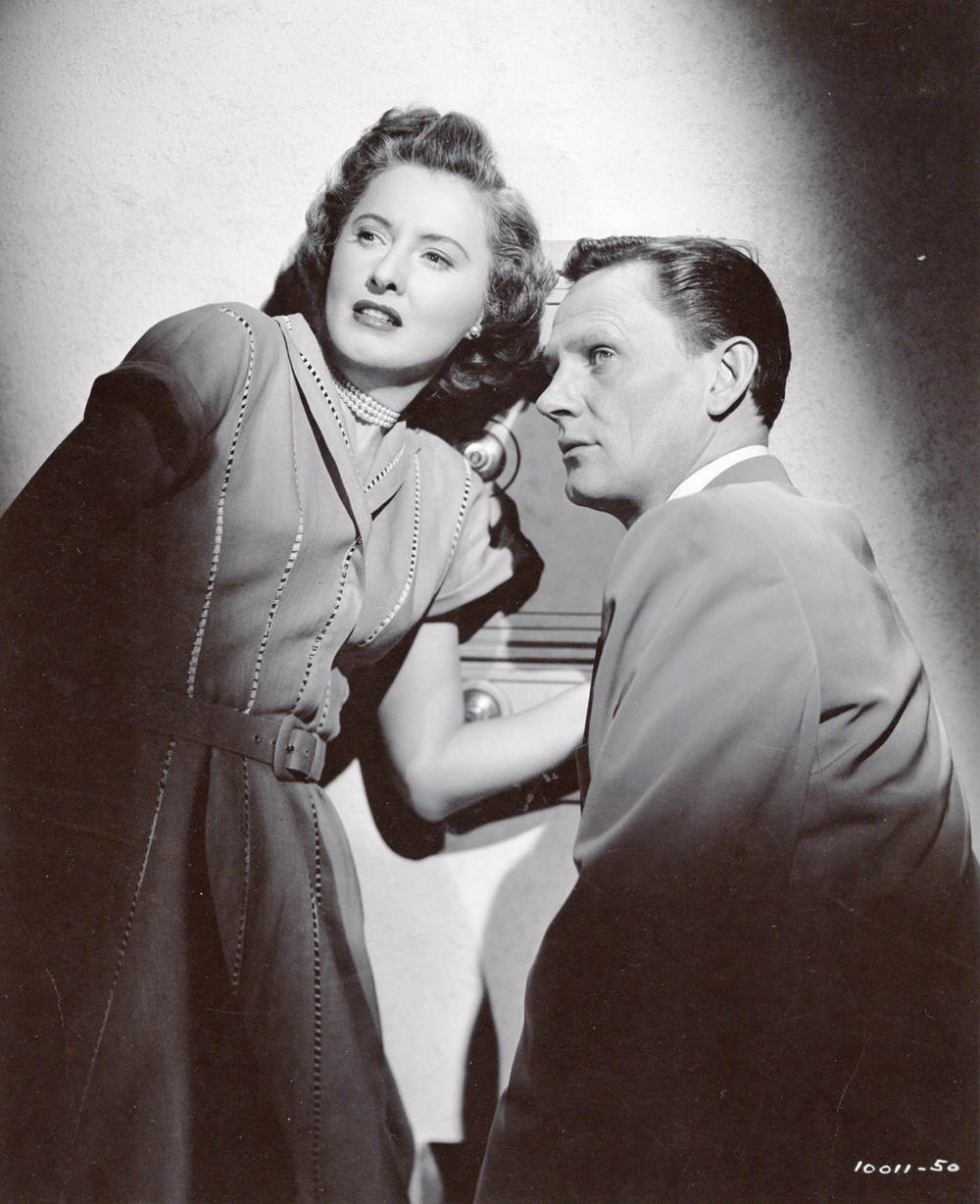 Barbara Stanwyck as Thelma Jordan wearing a dress decorated with open vertical stitching in the 1949 film "The File on Thelma Jordan."