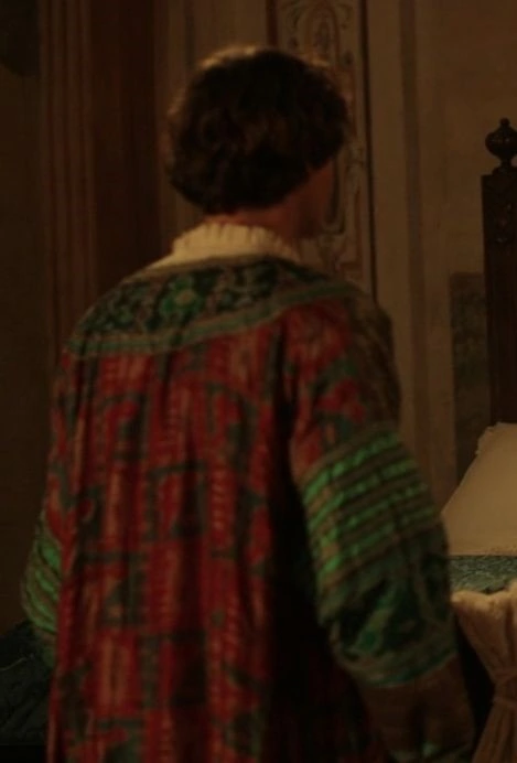 Alessandro Sperduti as Piero de' Medici wearing a blue, red, and turquoise silk coat with gold detailing in the episode "Temptation" of the 2016 series "Medici: Masters of Florence."