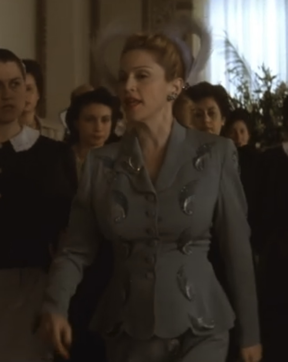 Madonna as Eva Perón wearing a blue wool suit decorated with beading in the 1996 film "Evita."