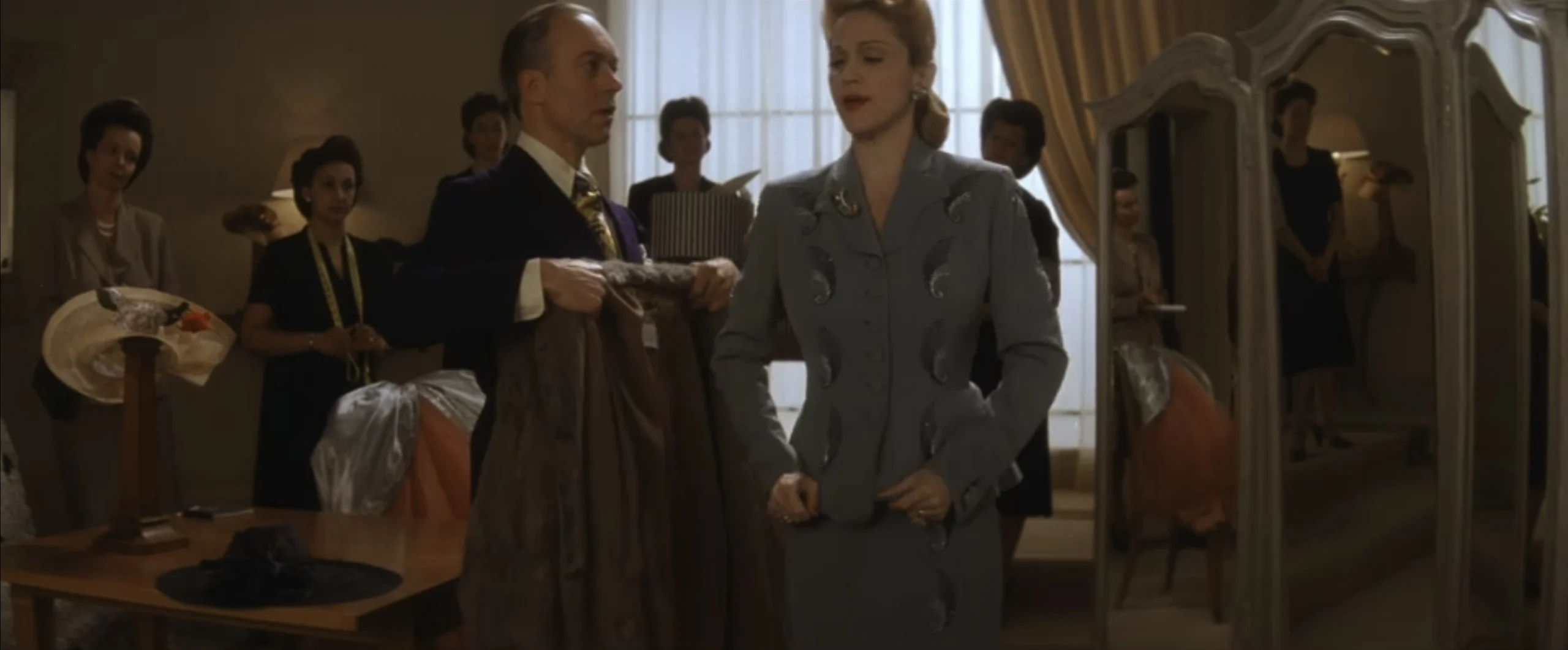 Madonna as Eva Perón wearing a blue suit decorated with beading in the 1996 film "Evita."