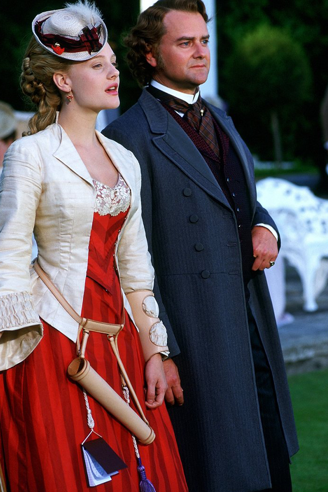 Romola Garai as Gwendolen Harleth wearing a striped red gown decorated with lace in the 2002 miniseries "Daniel Deronda."