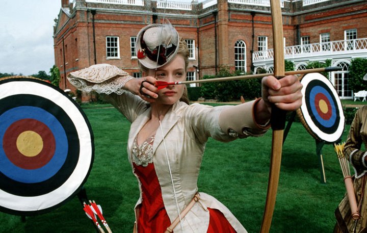 Romola Garai as Gwendolen Harleth wearing a striped red gown decorated with lace in the 2002 miniseries "Daniel Deronda."