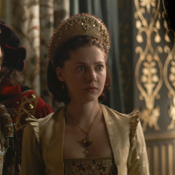 Catherine Steadman as Joan Bulmer wearing a gold French hood with red beading in the 2010 series "The Tudors."