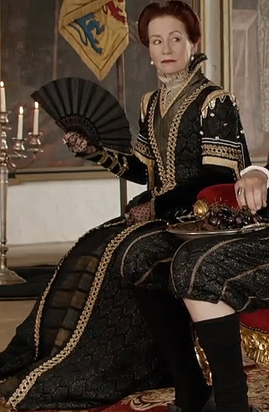 Ulrike Krumbiegel as Edeltraud wearing a black and gold gown in the 2013 film "Märchenperlen: Die goldene Gans."