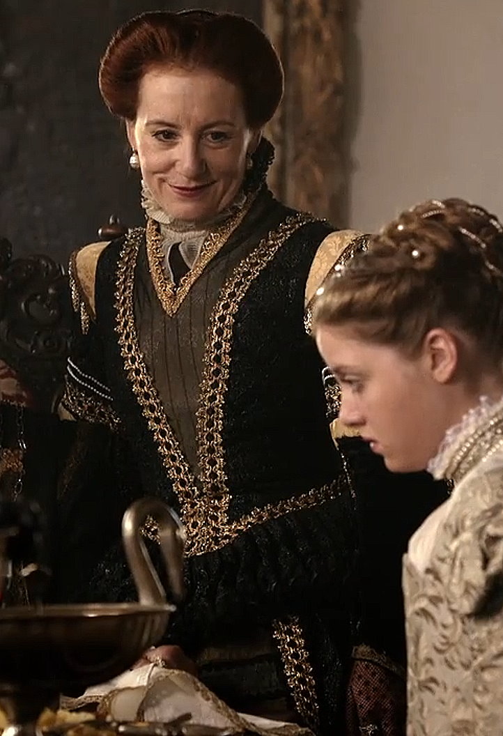 Ulrike Krumbiegel as Edeltraud wearing a black and gold gown in the 2013 film "Märchenperlen: Die goldene Gans."