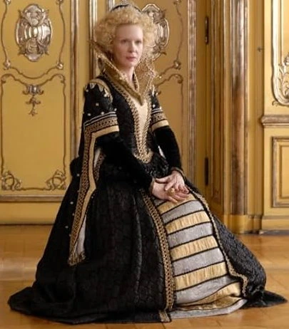 Sunnyi Melles as Königsmutter (The King's Mother) wearing a black and gold gown in the 2009 film "Sechs auf einen Streich: Die kluge Bauerntochter" (Finest Fairy Tales: The Peasant's Wise Daughter).