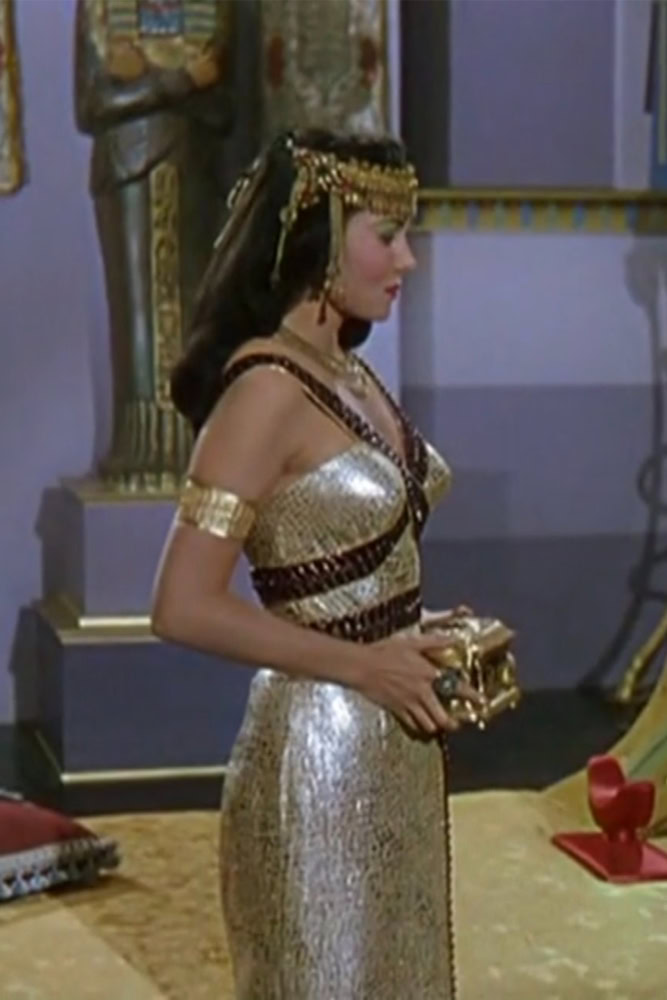 Rhonda Fleming as Cleopatra wearing a gold and purple bejeweled gown in the 1953 film "Serpent of the Nile."