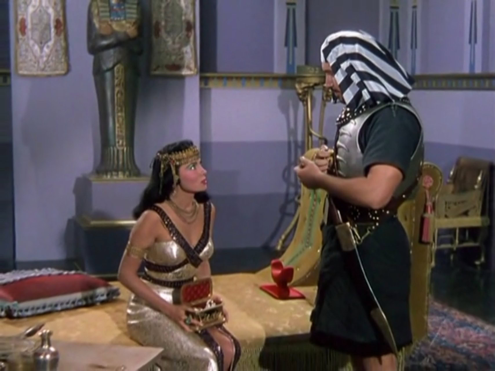 Rhonda Fleming as Cleopatra wearing a gold and purple bejeweled gown in the 1953 film "Serpent of the Nile."