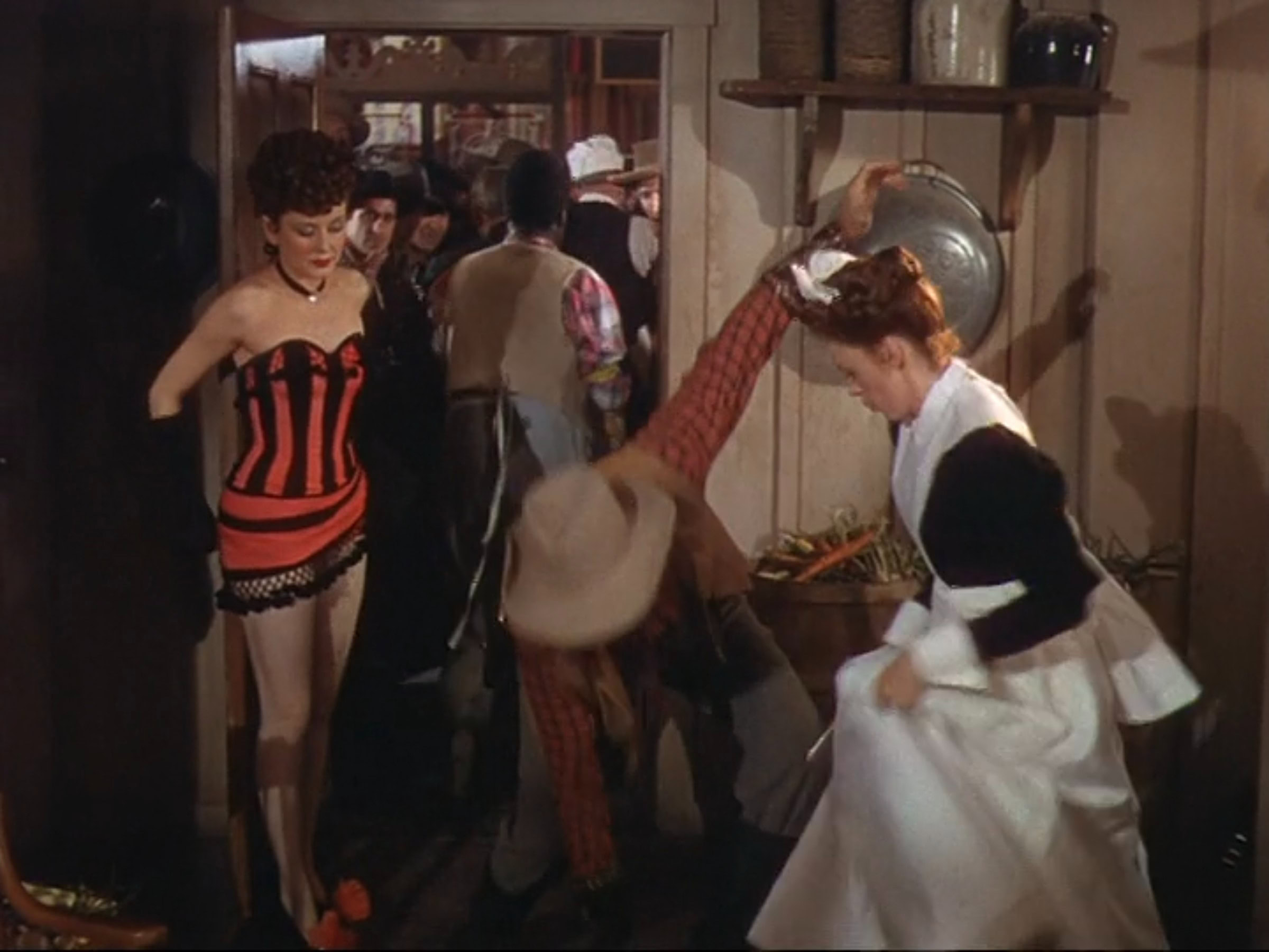 An extras as a showgirl wearing a black and red striped showgirl costume in the 1946 film "The Harvey Girls."