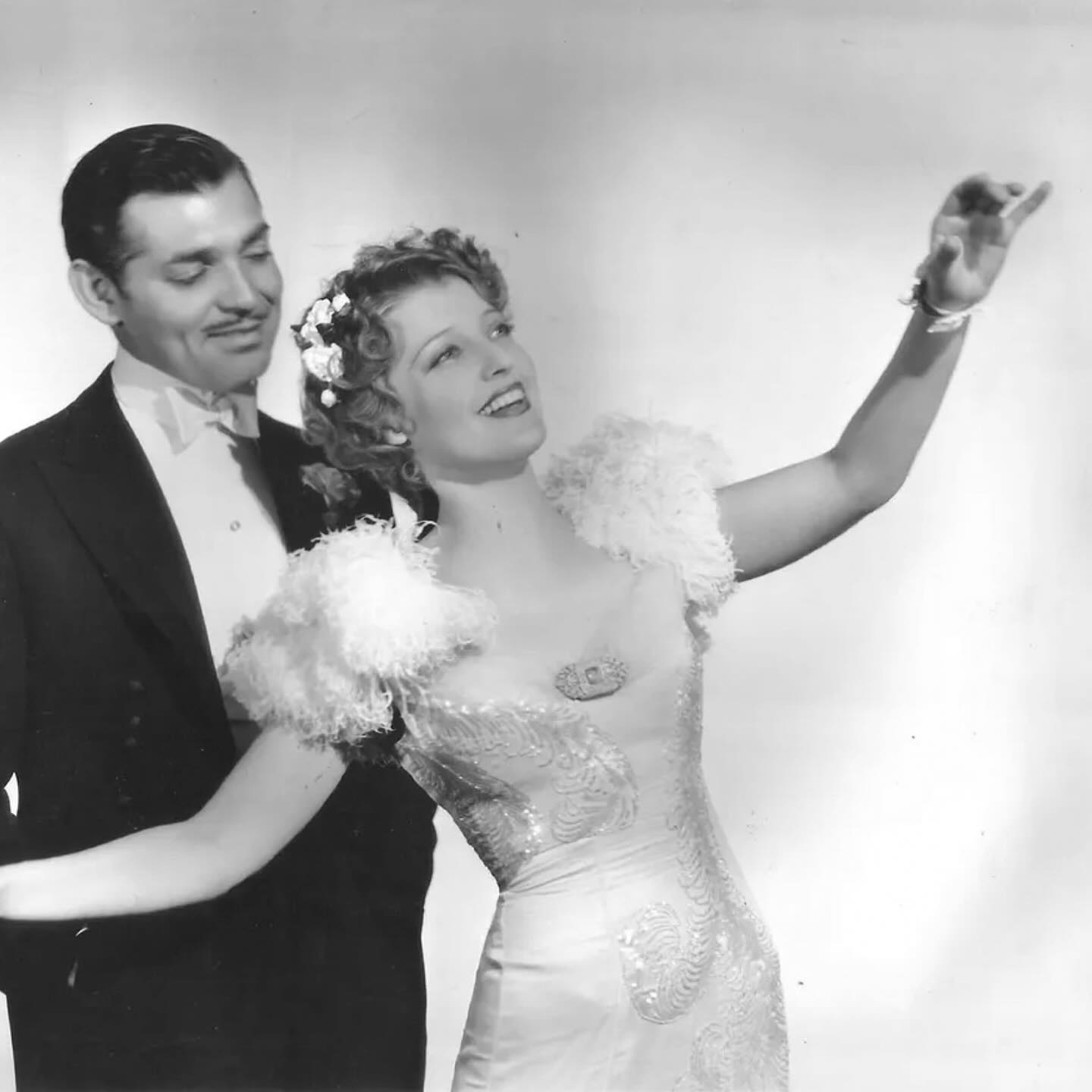 Jeanette MacDonald as Mary Blake wearing a sequined gown with feathered sleeves in the 1939 film "San Francisco."