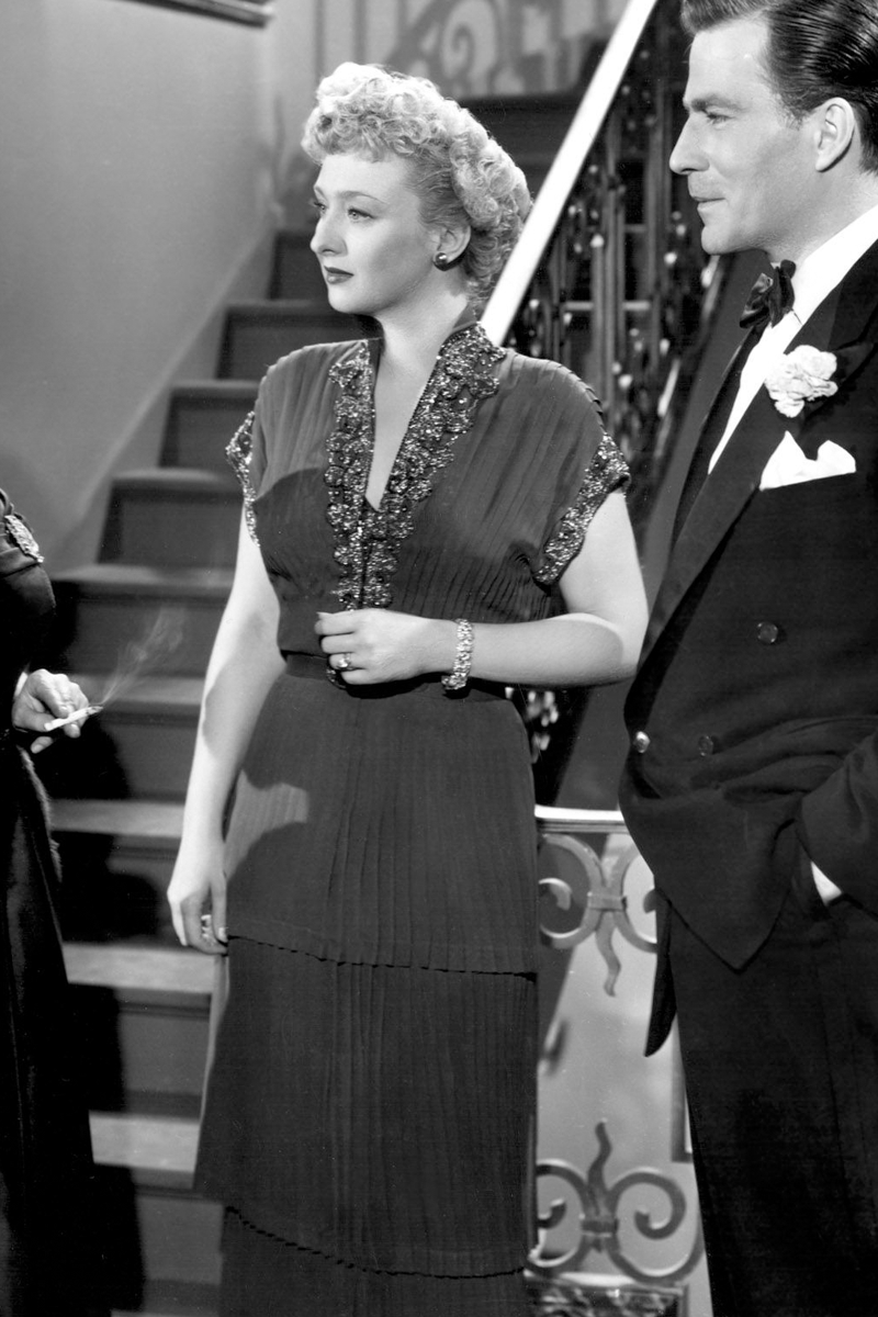Celeste Holm as Karen wearing a gown with a tiered skirt in the 1950 film "All About Eve."