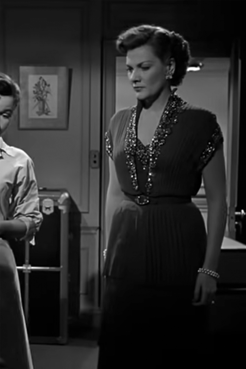 Marjorie Hoshelle as Kay Prentiss wearing a gown with a tiered skirt in the 1953 film "Dangerous Crossing.