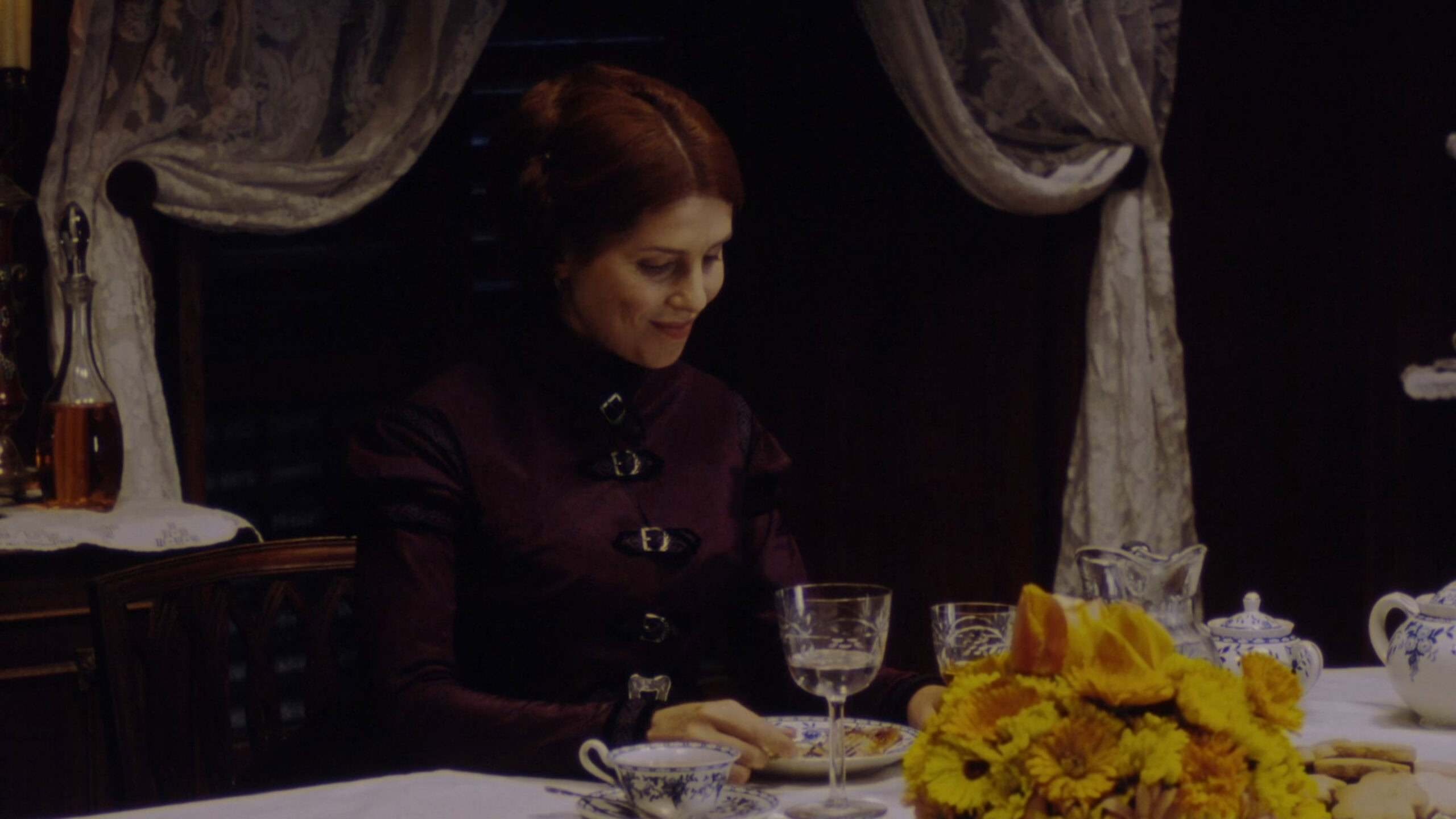 Sadie Frost as The Governess wearing a purple dress with black detailing in the 1999 film "Presence of Mind."
