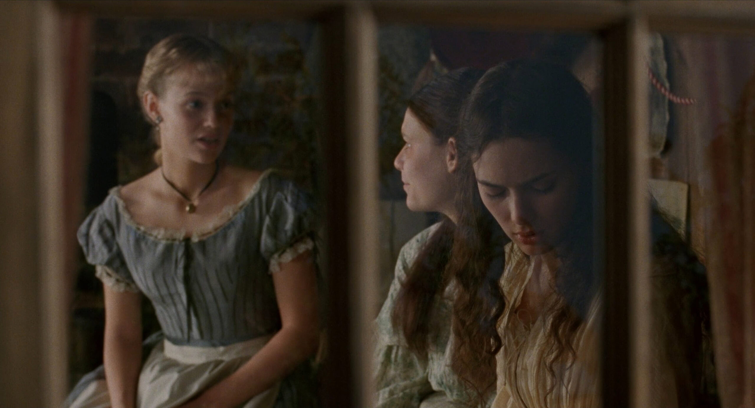 Samantha Mathis as Amy March wearing a blue striped dress decorated with lace and ribbon in the 1994 film "Little Women."