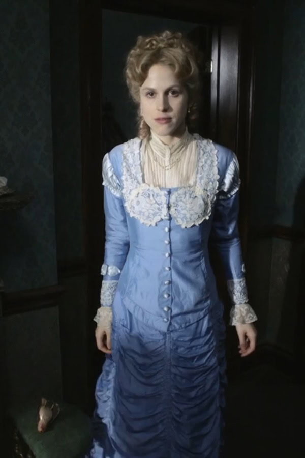 Amanda Hale as Mrs. Agnes Rackham wearing a blue gown decorated with lace in the 2011 miniseries "The Crimson Petal and the White."