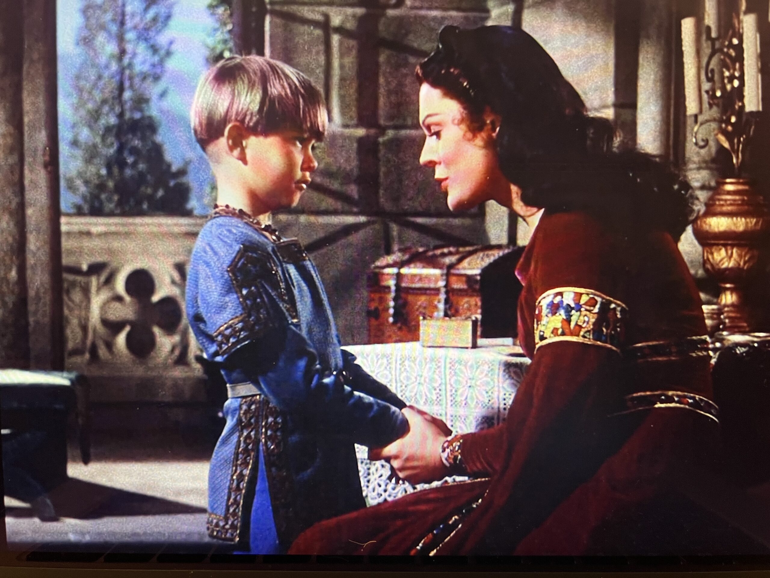 Closeup of Lynn Baggett as Francesca talking to her son, showing a side view of the purple/burgundy dress
