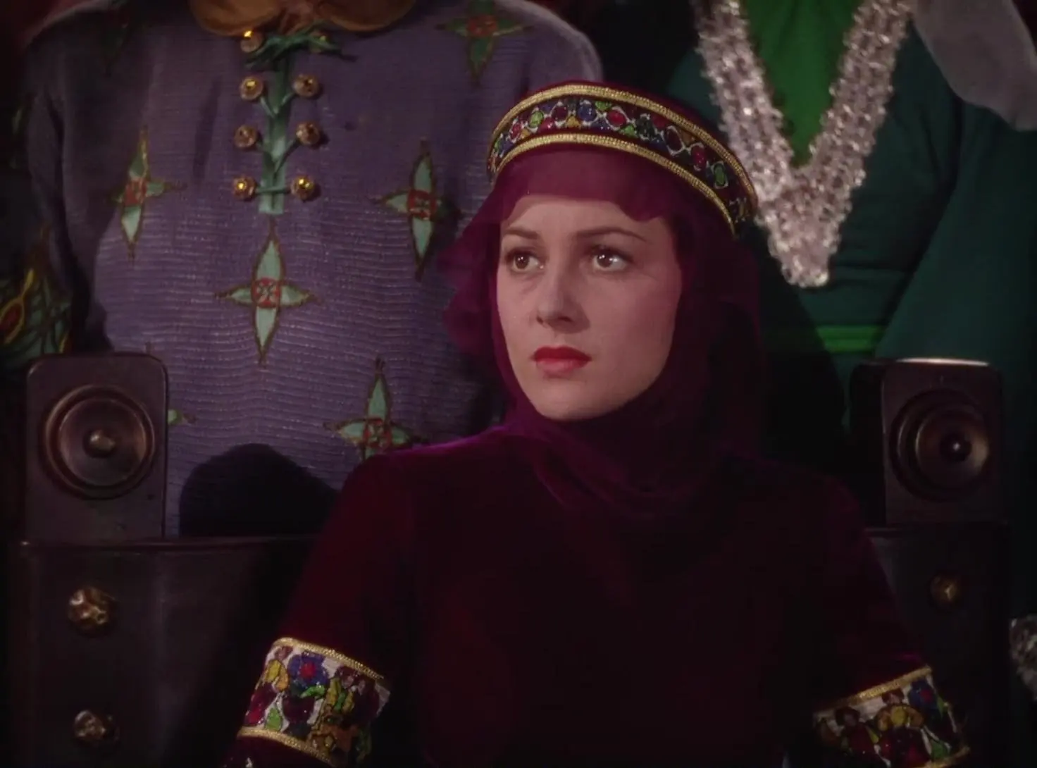 Closeup of Oliva De Havilland in the Adventures of Robin Hood (1938), showing the high-necked burgundy dress